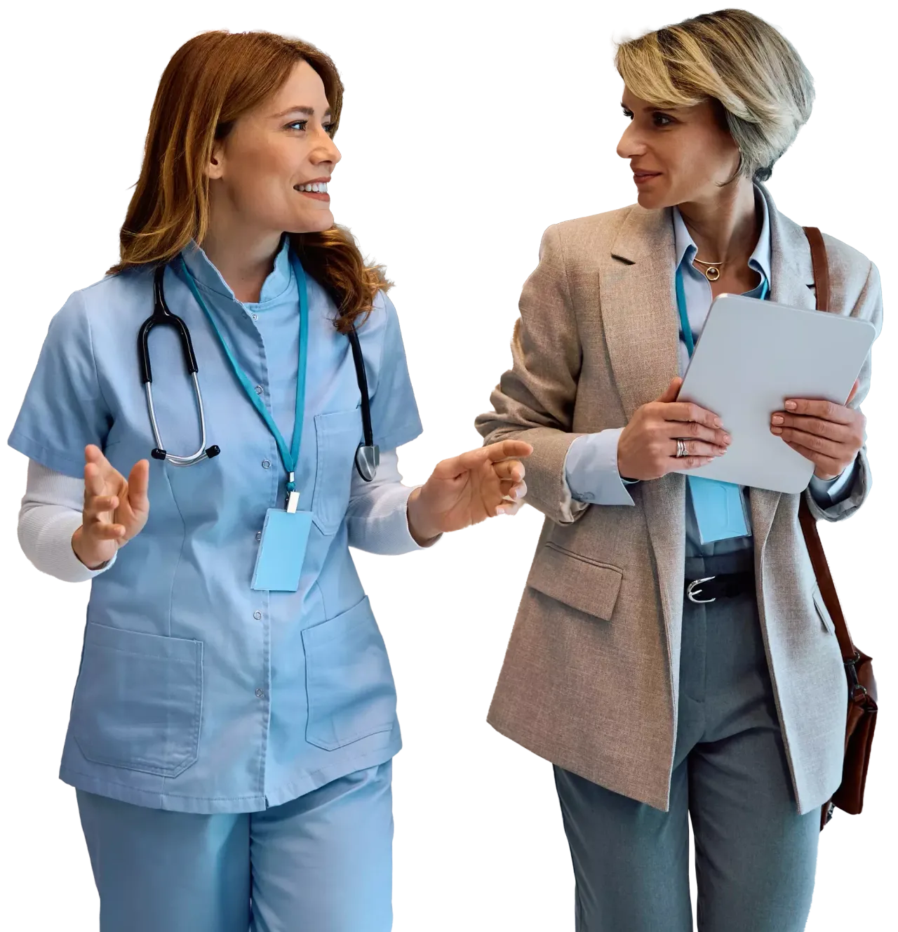 Two women, a nurse and a business professional, walk together smiling and conversing.